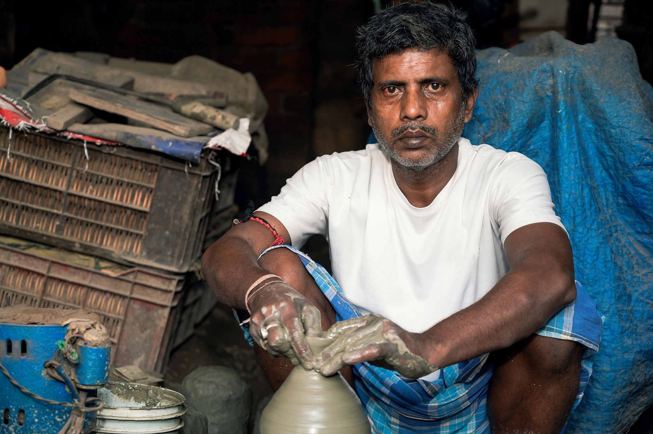 Potter shaping clay on a wheel