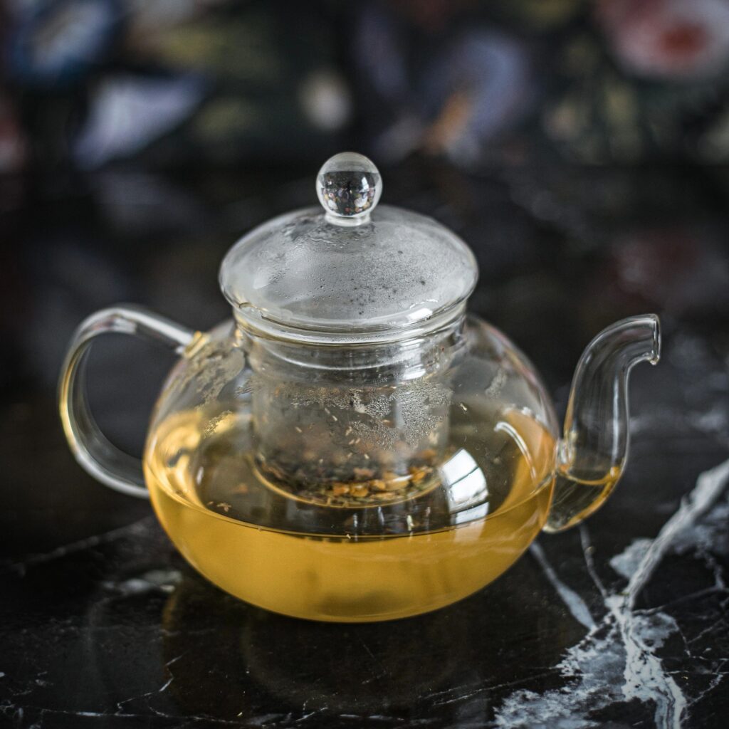 Portrait square cropped side angle of camomile tea preparation in kitchen