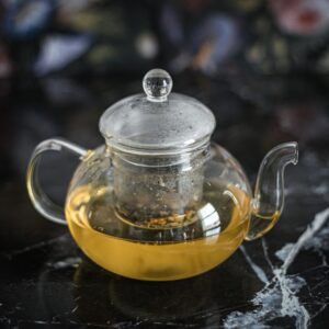Portrait square cropped side angle of camomile tea preparation in kitchen