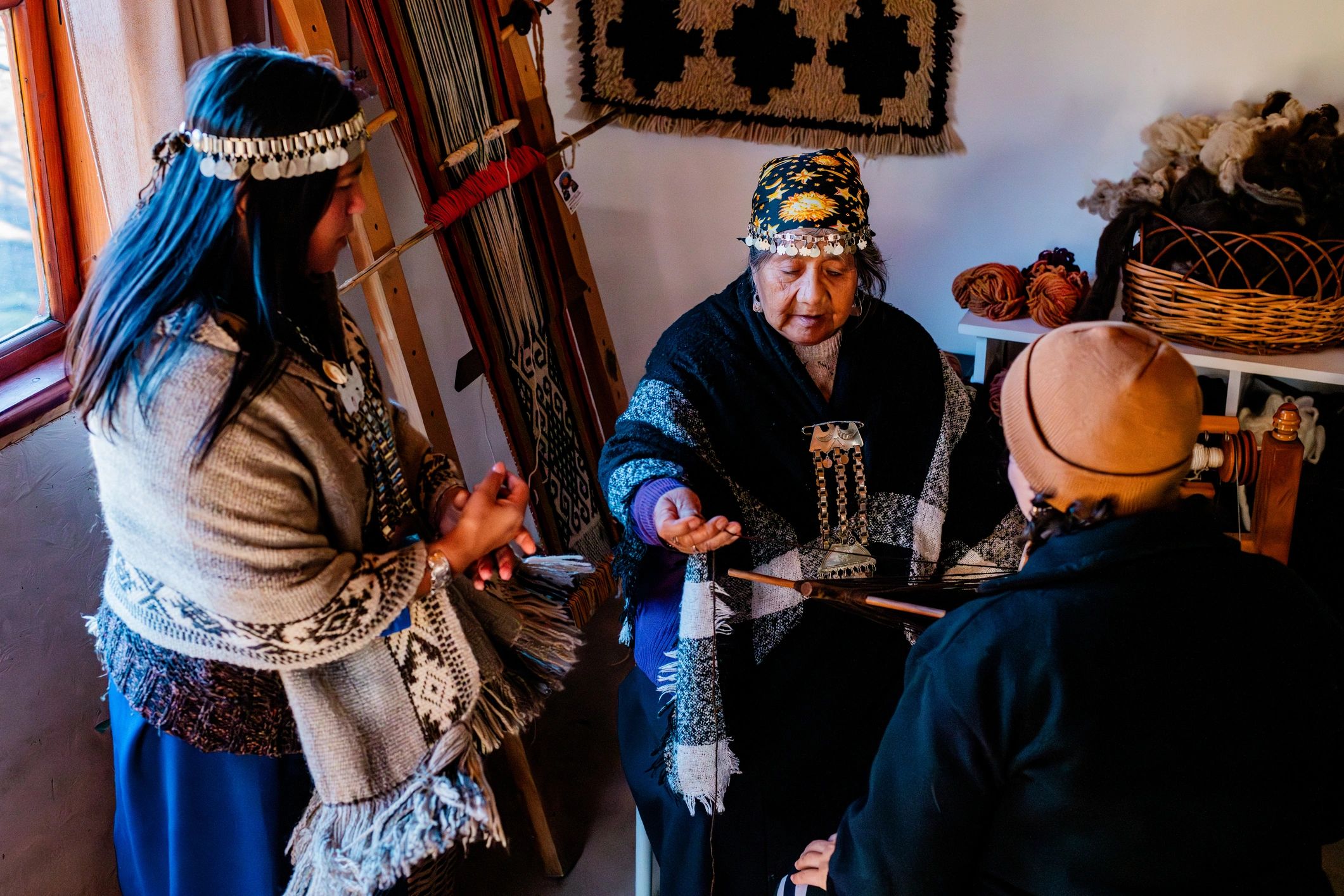 Woman teaching traditional textile weaving in a community setting
