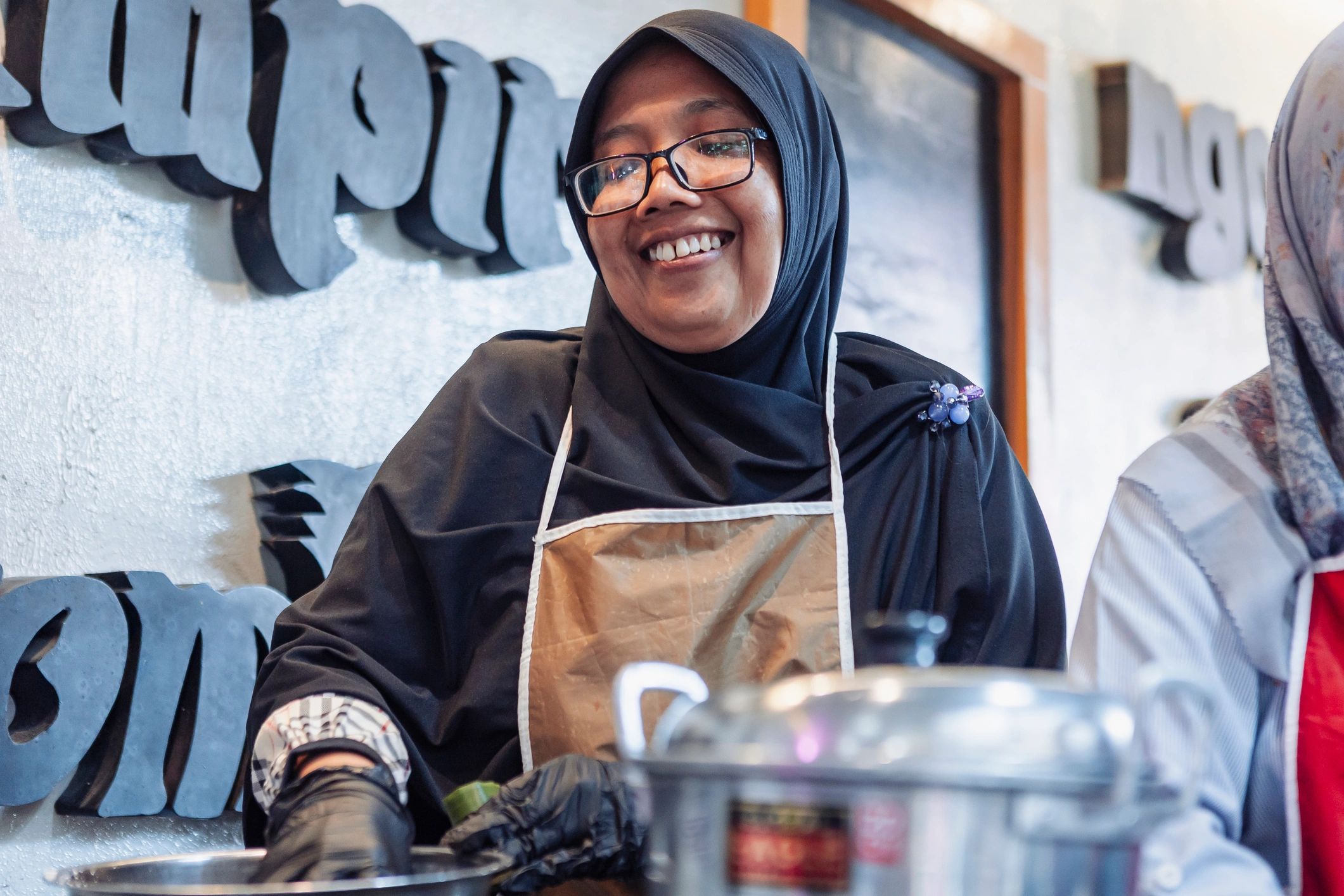Woman in cultural cooking workshop wearing a hijab